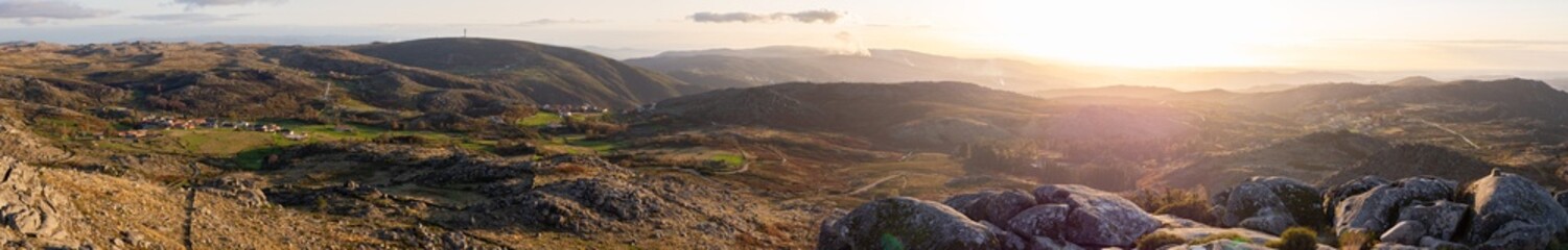 Huge amazing panorama landscape of mountain range with rocks and village during sunset in serra da...