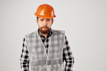 bearded man in orange hard hat construction professional light background