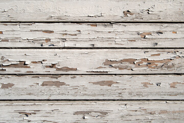 Texture of planks of old wood with peeling white paint