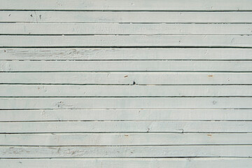 Texture of planks of old wood with peeling white paint