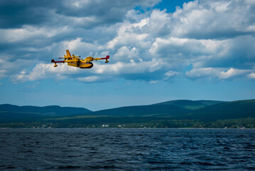 Fototapeta na wymiar Canadair CL-415 water bomber working to extinguishe a forest fire in eastern Quebec, Canada.