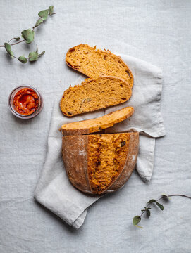 Red pesto sauce and bread on table