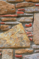 Traditional stone wall, with yellow, orange and blue stones. Ideal for background