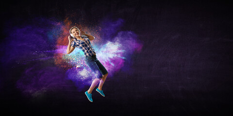 Obraz na płótnie Canvas Woman wearing headphones jumping . Mixed media