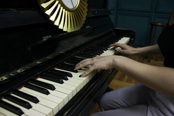 woman playing the piano in a dark blue office