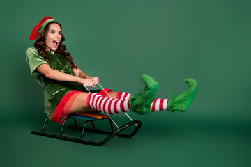 Full length body size view of attractive cheerful childish girl elf sleighing having fun isolated...