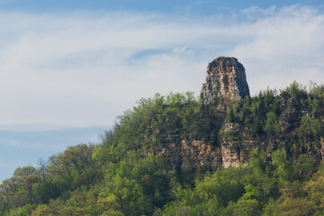 A Rock Formation On Top Of A Hill In Spring - obrazy, fototapety, plakaty