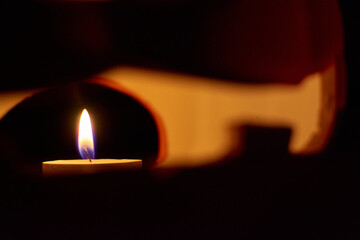 A candle inside a carved pumpkin - halloween concept