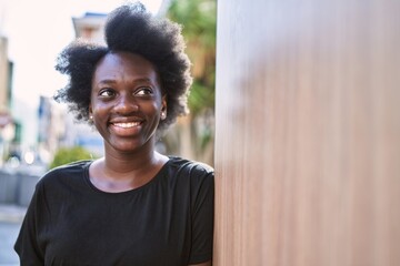 Fototapeta premium Young african woman smiling confident at street