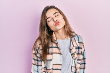 Fototapeta premium Young caucasian girl wearing casual clothes looking at the camera blowing a kiss on air being lovely and sexy. love expression.