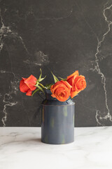 three roses tomatoes in a ceramic vase, beauty of nature, decorative element with detail in the texture of its petals, natural flowers withering in studio with black background