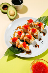 Japanese sushi rolls with salmon, shrimp, smoked eel and red caviar