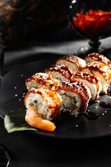 Japanese sushi rolls with salmon, shrimp, smoked eel and red caviar