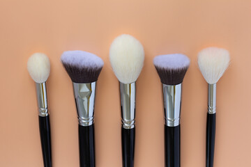 makeup brushes on colored backgrounds. View from above