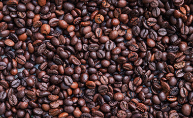 Brown and black coffee beans. Roasted arabic espresso coffee grains.