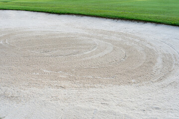 Fototapeta na wymiar The sandpit on the golf course fairway is used as a hurdle for athletes to compete