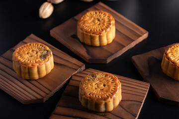 Mooncakes in a vintage tray Chinese festive snacks on black background