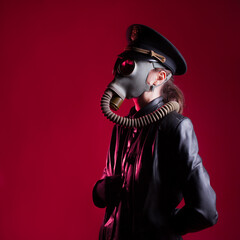 fantastic Nazi in black leather clothes and a cap with a gas mask on face, - obrazy, fototapety, plakaty