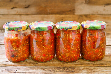 Homemade canned vegetables. Vegetable caviar in glass jars.