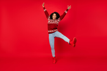 Full length body size photo woman smiling careless childish wearing sweater isolated bright red color background