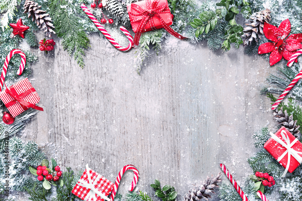 Wall mural Christmas and New Year background with fir branches and snowfall on wooden white board