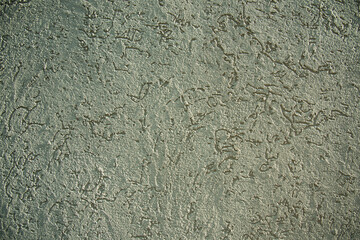 Gray textured background. Concrete wall, embossed texture. Patterned concrete wall