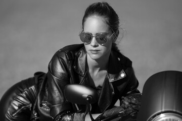young woman on a black motorcycle