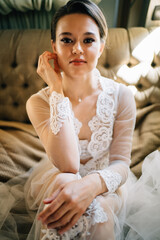 a bride in a lace robe sitting in bed. morning before the wedding.