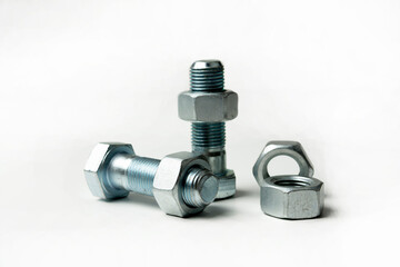 several large bolts and nuts on a white background