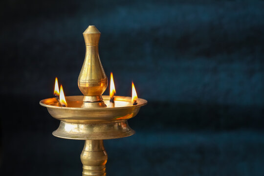 Onam Diwali vishu celebration Indian festival flowers marigold flowerbed lighted oil lamp Nilavilakku Diya colors Rangoli decoration greetings Dipavali Kerala Tamil nadu North India Mumbai Delhi India