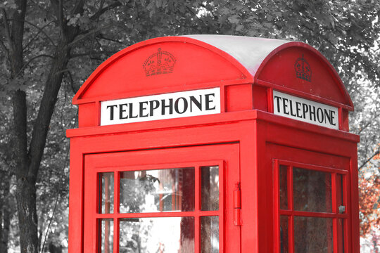 Black and white photo with red telephone booth in classic english style on black and white background in style of black and white retro photo as sample of black and white photo with red accent