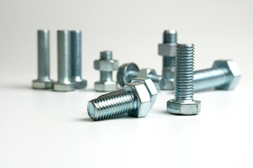 Several metal bolts and nuts on a white background