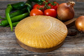 Smoked cheese on wood background