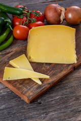 Gruyere cheese on wood background