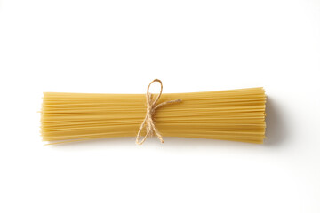 Top view of bunch of raw spaghetti pasta tied with rope isolated on white background.