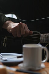 man playing guitar  and coffee