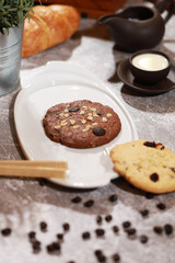 Fototapeta na wymiar Homemade Chocolate cookies and peanut cookie put in white plate and milk.