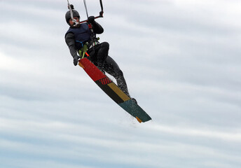 Trick by kitesurfer man in high  jump