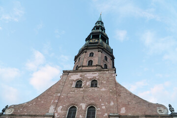 Fototapeta premium Riga St. Peter’s Church facade with the tower (Latvia) - one of the oldest and most valuable monuments of medieval architecture in the Baltic States included among the UNESCO World Heritage sites.