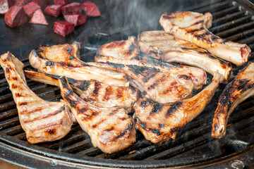 Lamb cutlets chops grilling on barbecue plate . Backyard BBQ grill cooking. Australia Day celebration