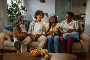 Friends drinking beer and having fun in the living room