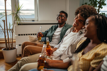 Happy friends hanging together on a home party.