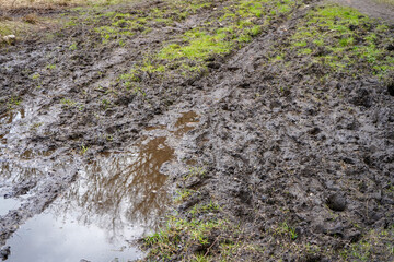 Close up of a muddy flooded dirt track