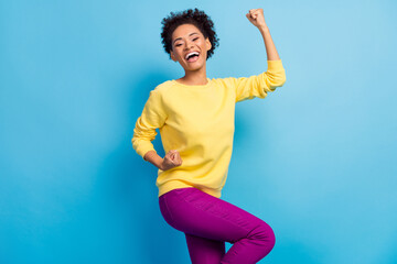 Photo portrait young girl smiling overjoyed gesturing like winner isolated pastel blue color background