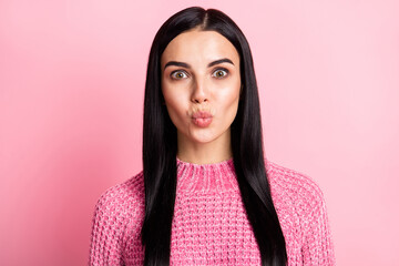 Photo of gorgeous young person kiss lips look camera wear sweater isolated on pastel pink color background