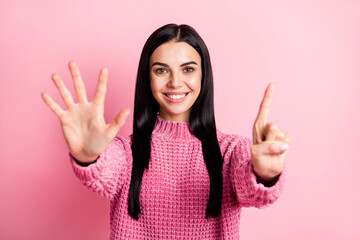 Photo of adorable person toothy smile arms fingers counting showing six isolated on pink color background