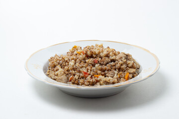 Buckwheat with meat on a white plate. Delicious and healthy diet food