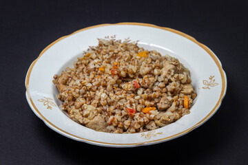 Fototapeta na wymiar Buckwheat with meat on a black background. Delicious and healthy diet food