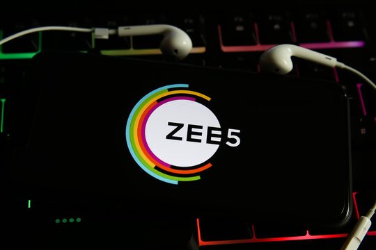 Viersen, Germany - May 9. 2021: View on mobile phone screen with logo lettering of movie streaming service zee5 on computer keyboard