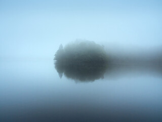 Wipperfürth, Germany - Lake Neyetalsperre in the morning mist. Beautiful autumn landscape in the Bergisches Land region. Minimalist Photography